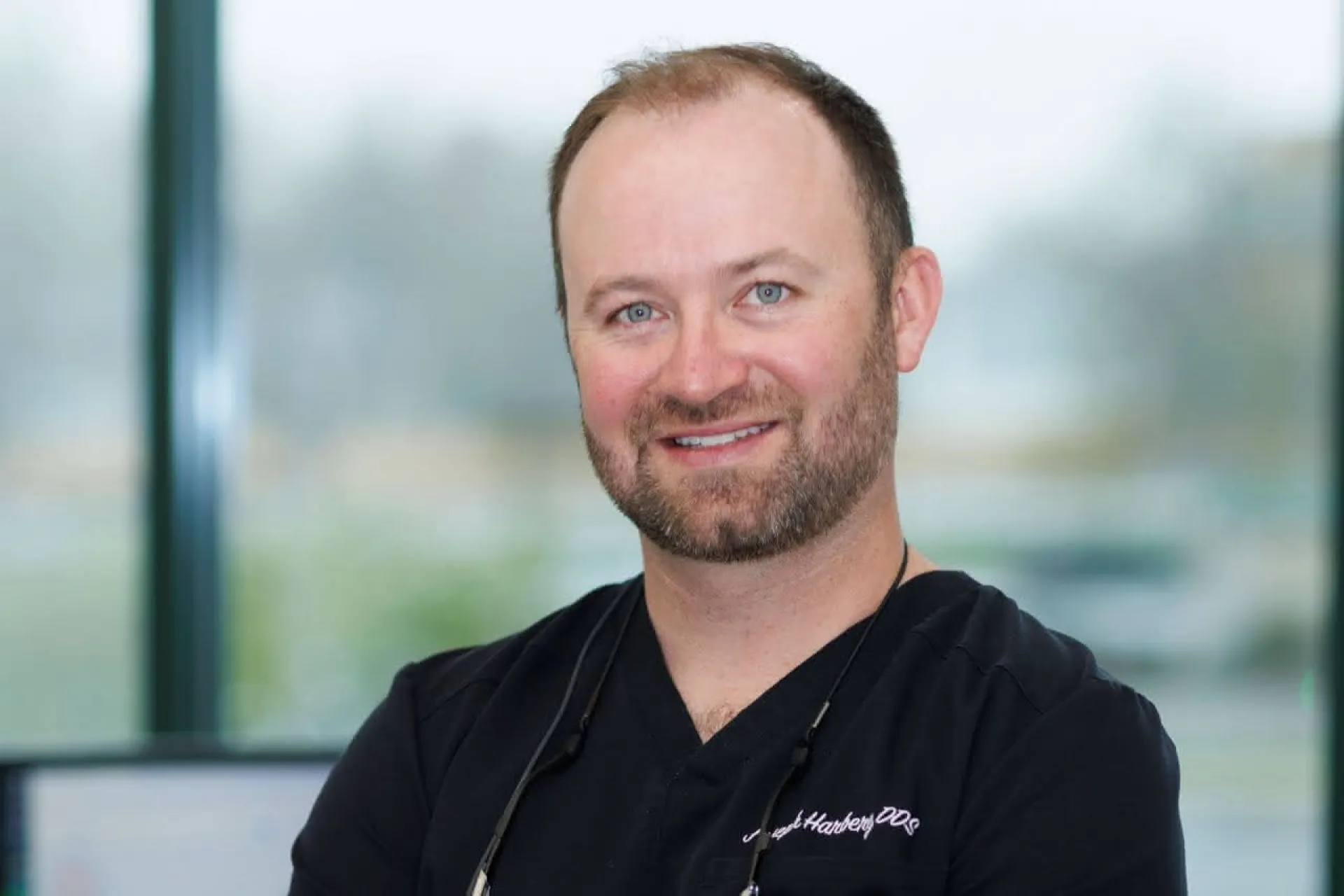 Dr. Harberg in front of a window