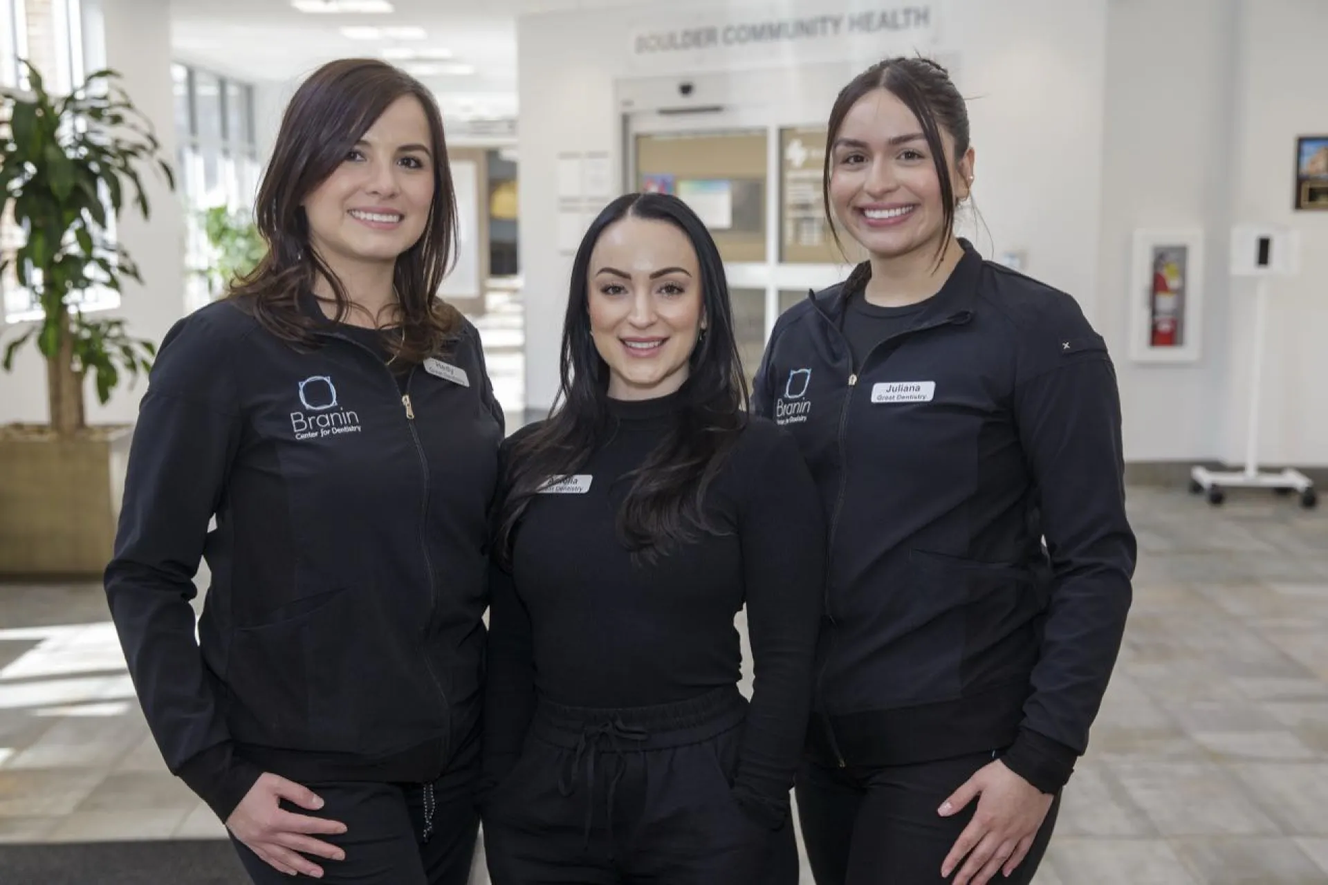 Three staff members standing in the lobby