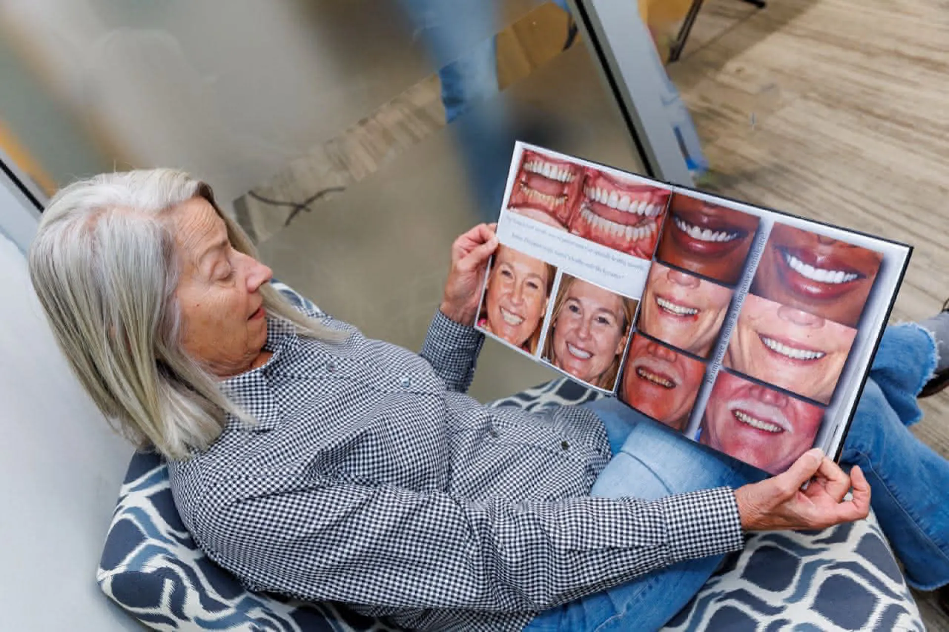 Patient looking at a book with smile examples