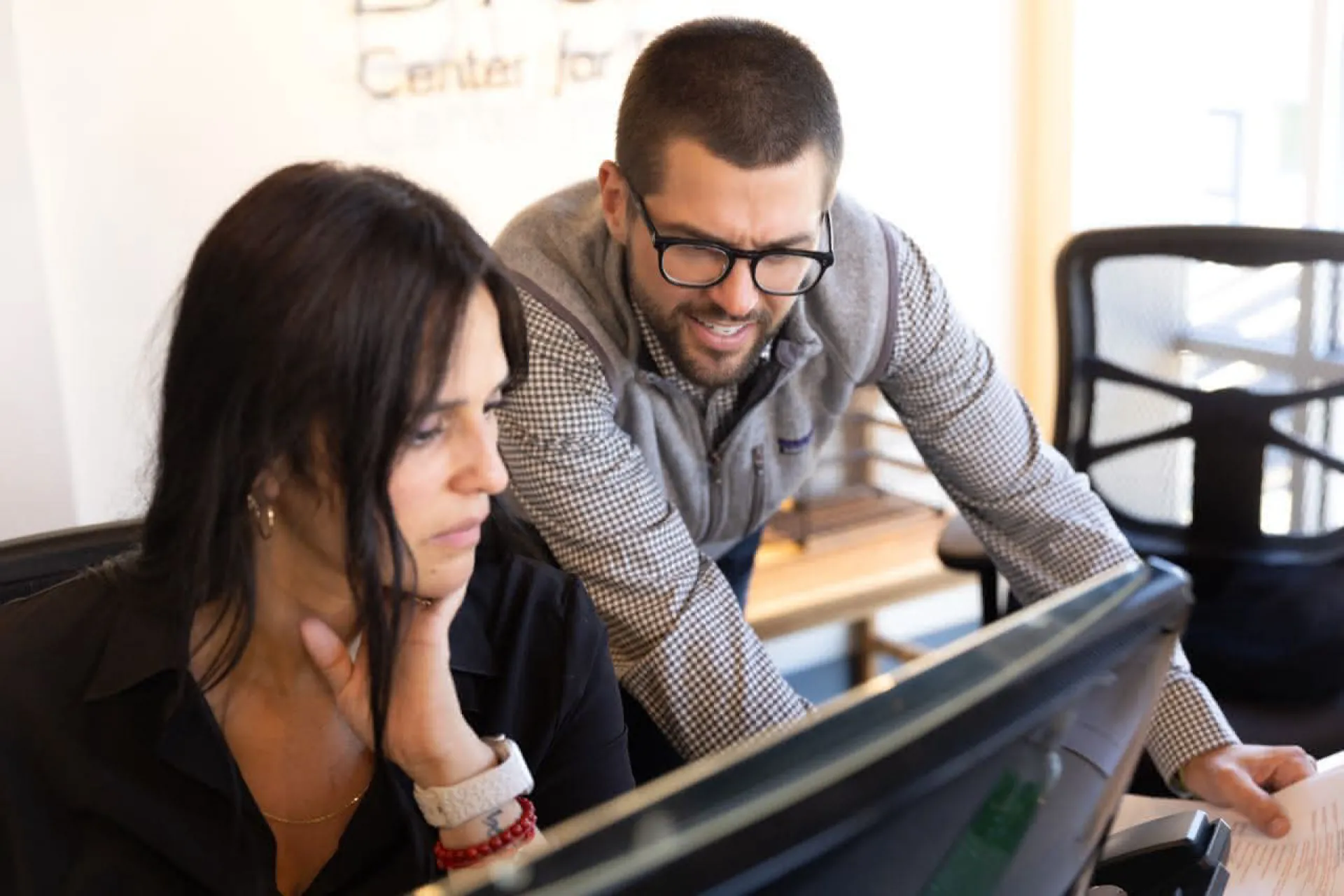 Two doctors looking at a computer monitor