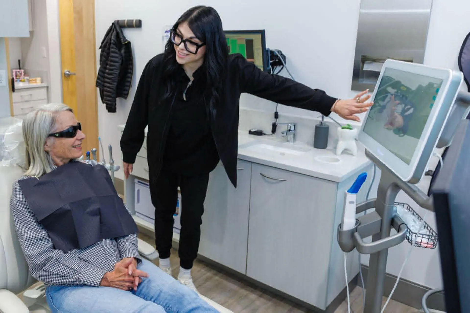 A person explaining a dental procedure to a patient