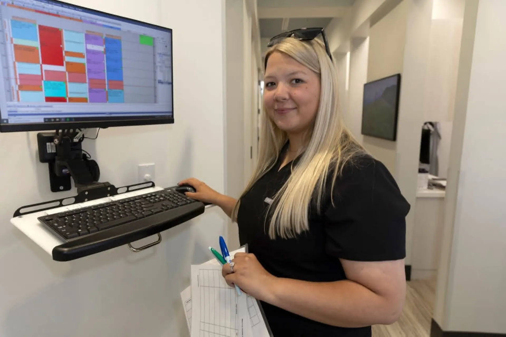 A staff member reviewing schedules at a standing desk