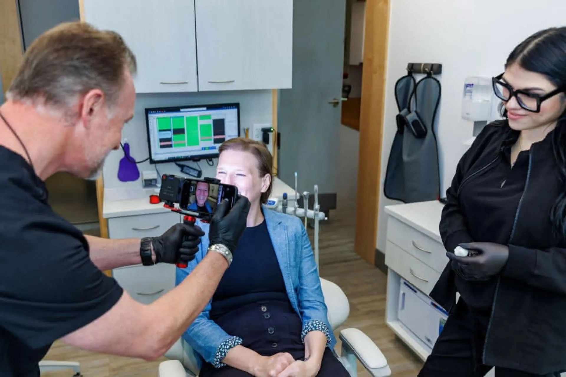 Dr. Bender and staff taking a photo of a smile