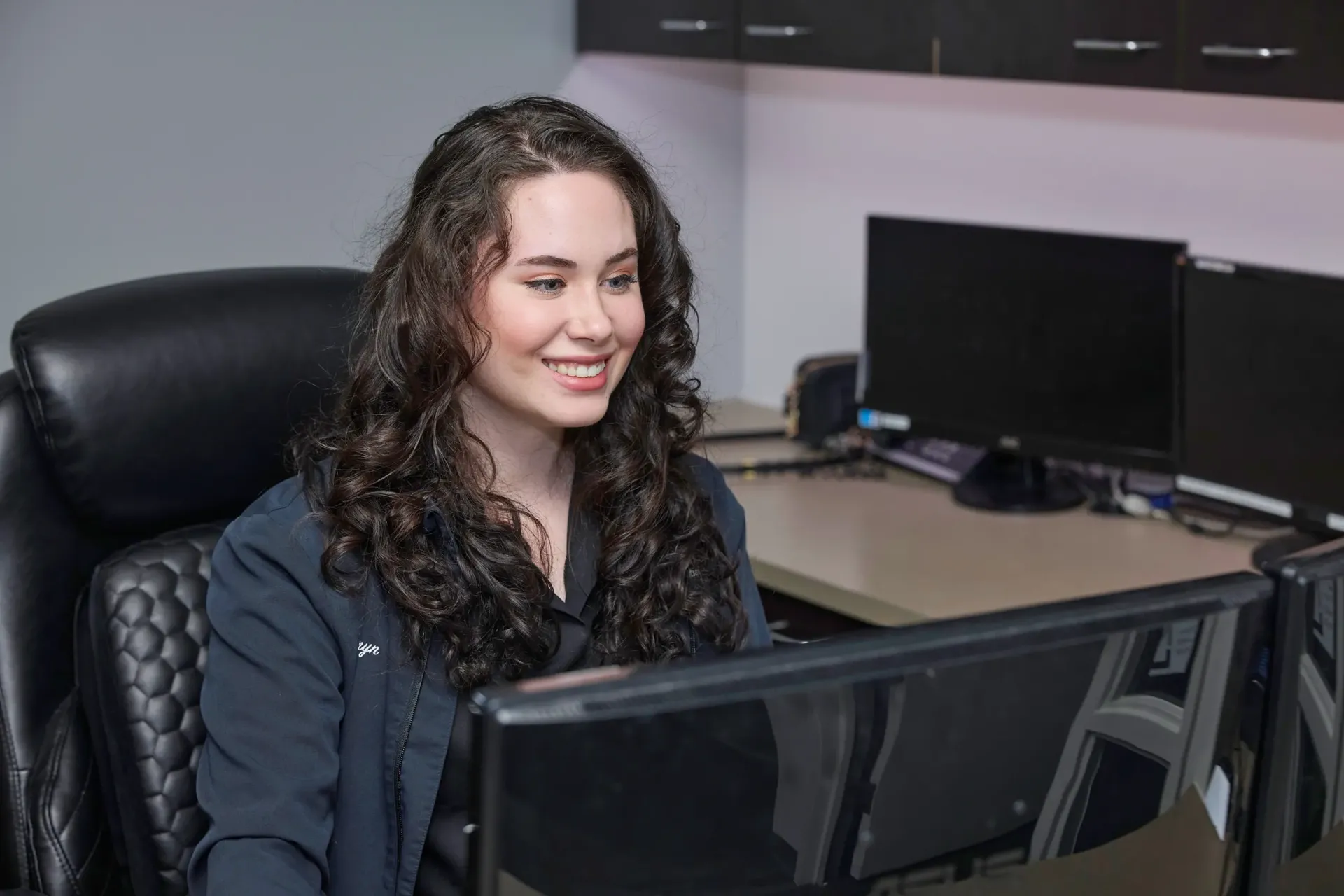 A team member looking at a computer monitor
