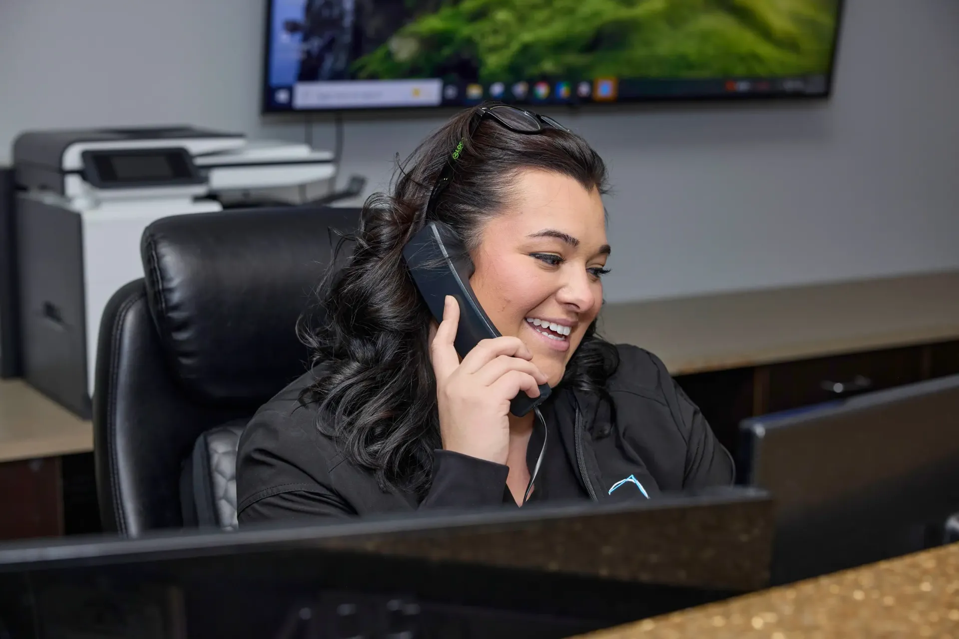 A team member at front desk on the phone