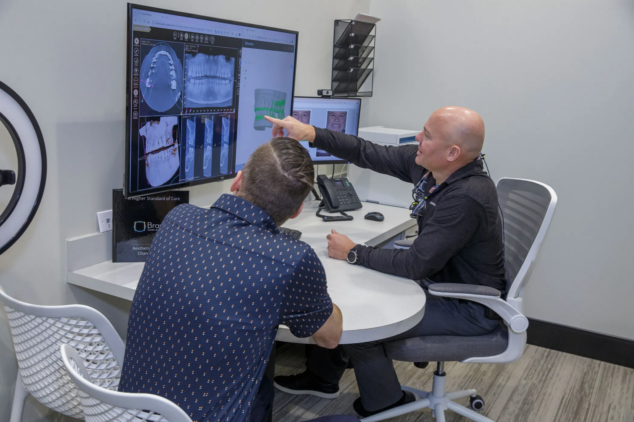 Dr. Dudley showing x-rays to a patient.