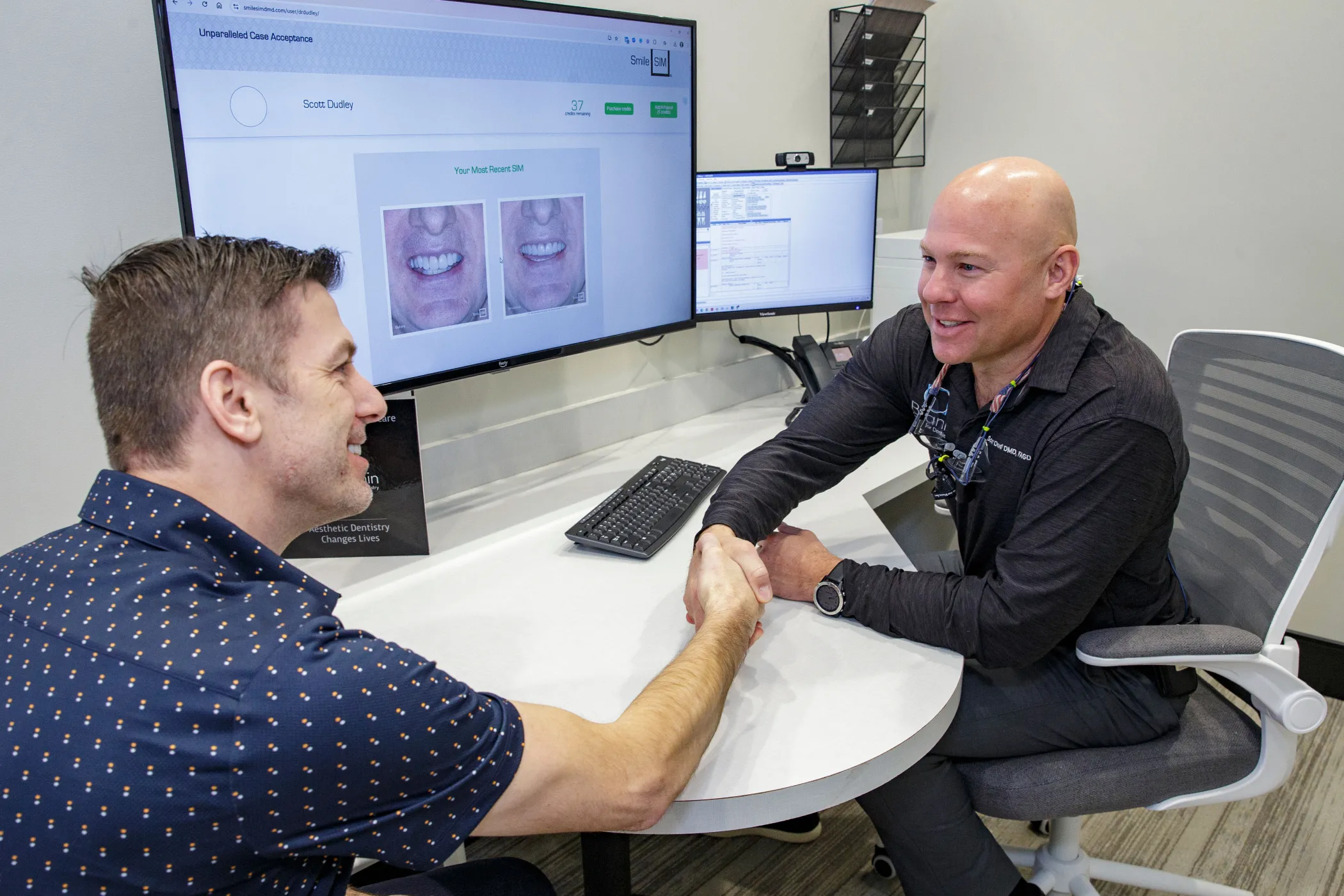 Dr. Dudley with a patient smiling.