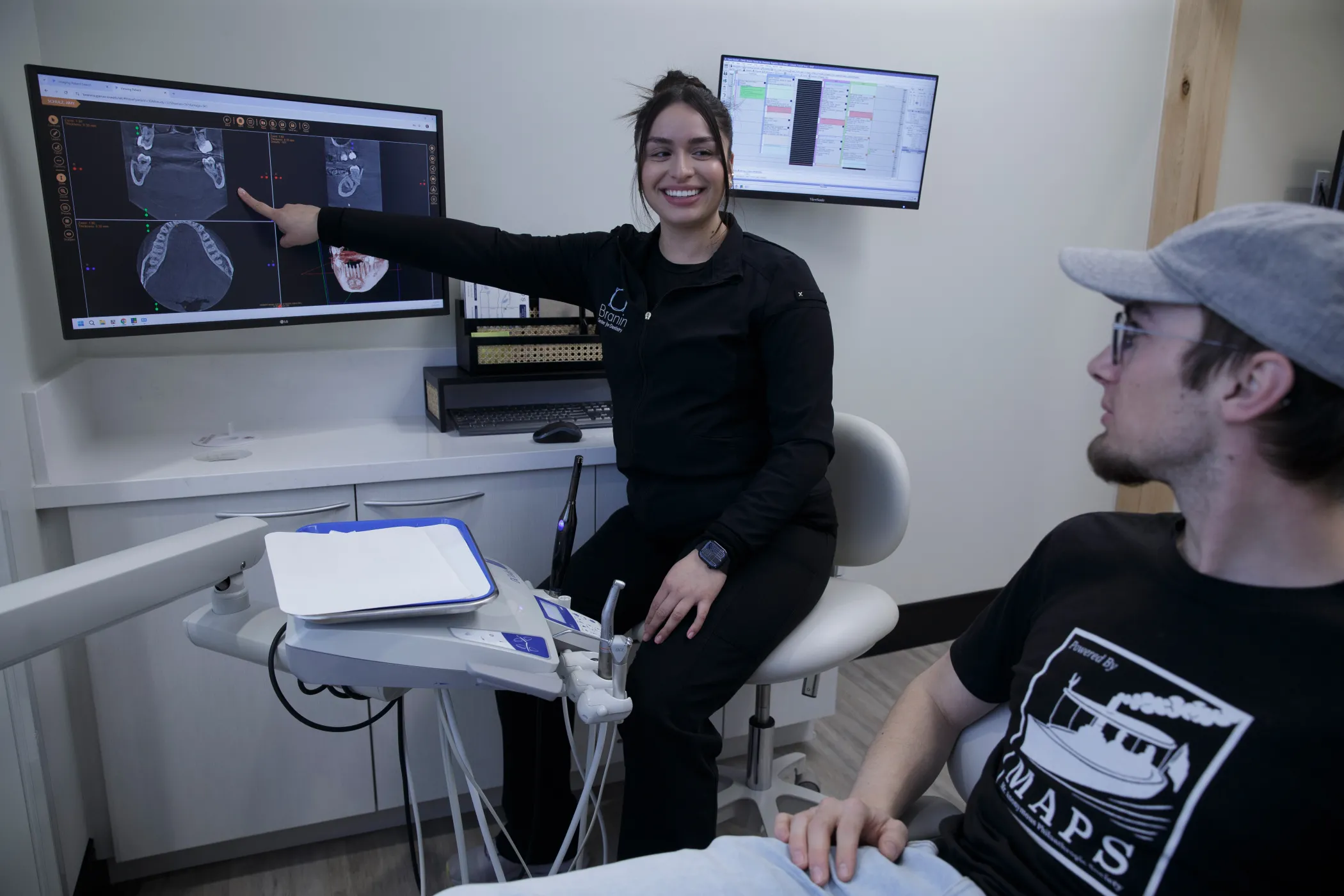 Superior team member showing x-rays to a patient.