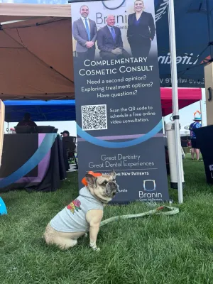 Dog in a shirt at a booth at chili fest