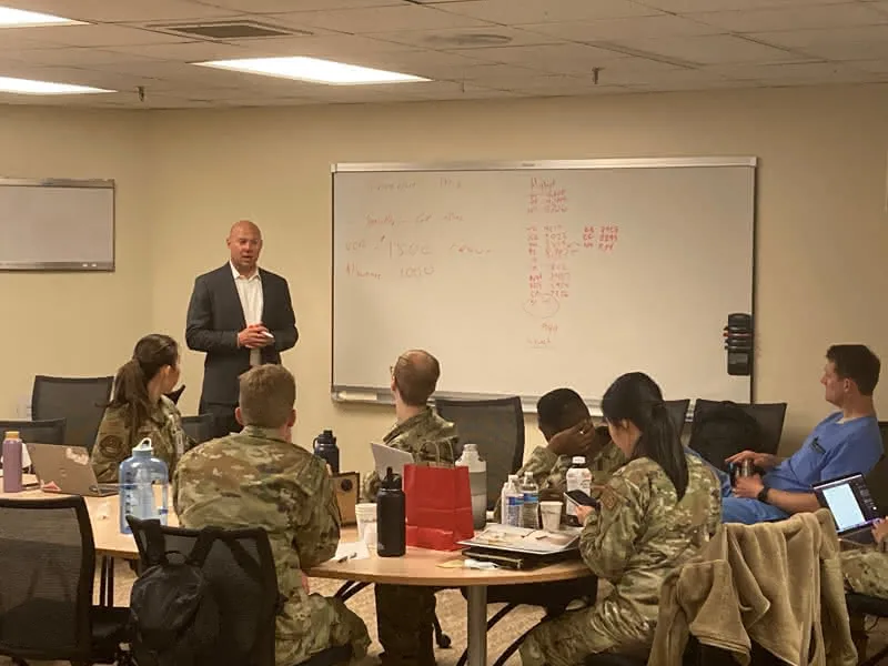 Scott Dudley speaking in front of military personnel
